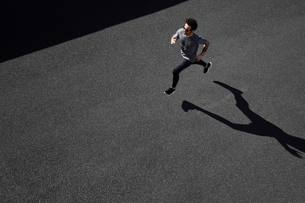 Man in sportswear running on road