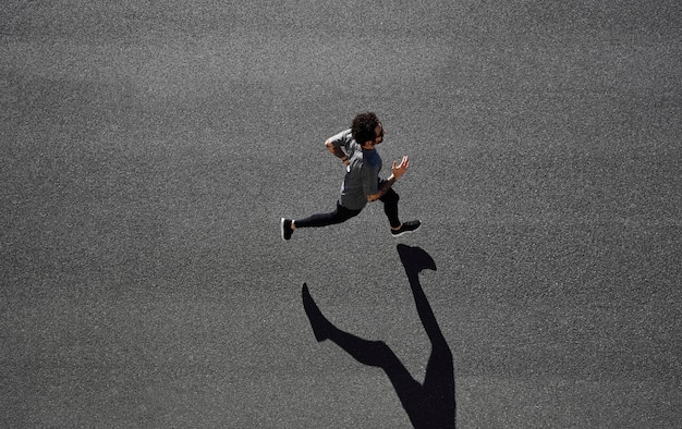 Man in sportswear running on road