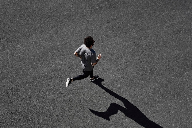 Man in sportswear running on road