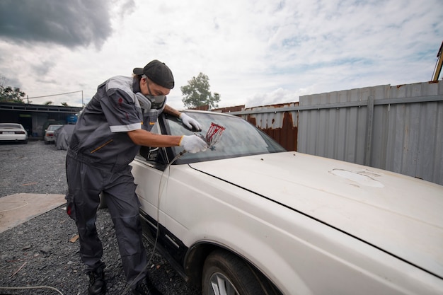 Free photo man spraying powder paint full shot