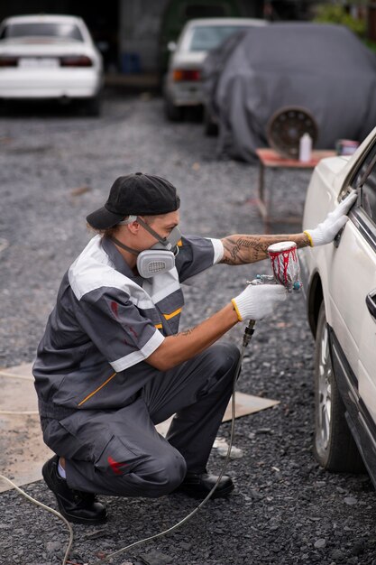 Man spraying powder paint full shot