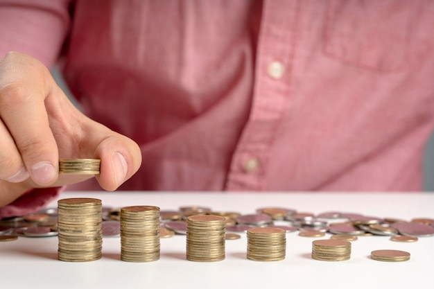 Free photo man stacking of coins