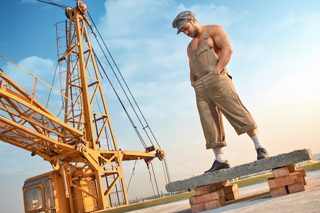 Man standing on concrete construction on high.