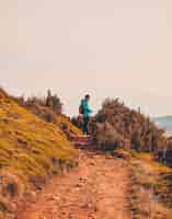 Free photo man standing on dirt road