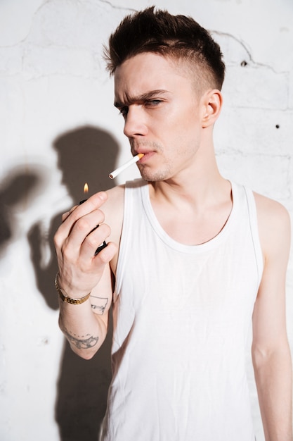 Man standing on floor with cigarette posing