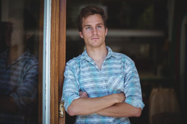 Man standing in front of shop entrance