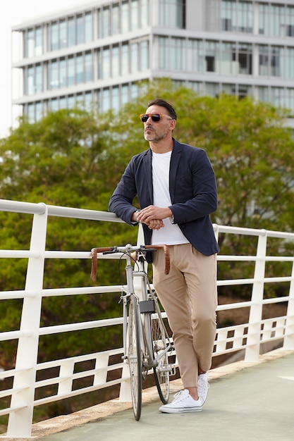 man standing next to his bike