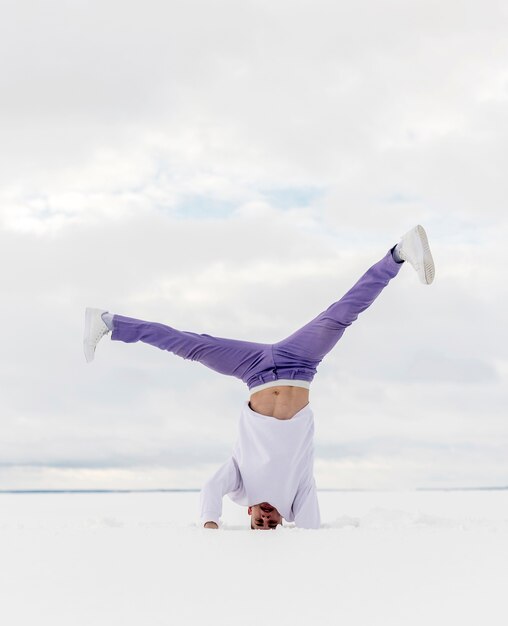 Man standing on his head while dancing to hip hop