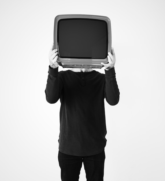 Free photo man standing and holding a tv