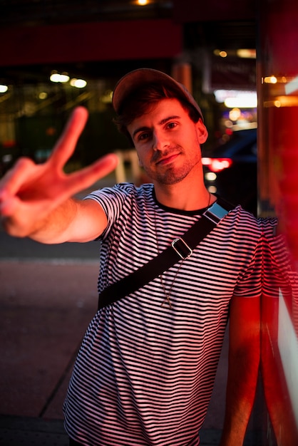 Man standing and showing peace sign