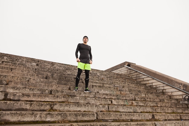 Free photo man standing on stairs