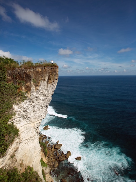 A man stands on a cliff