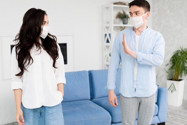 Man staying away from woman with face mask