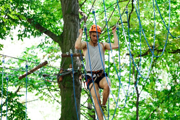 Man steps on the rope hanging in the air