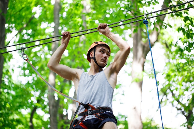 Man steps on the rope hanging in the air