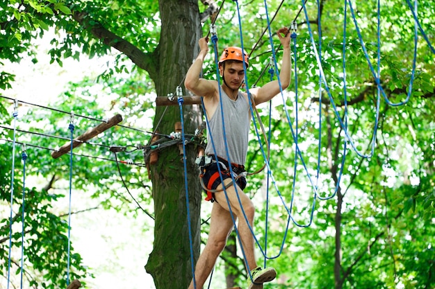 Man steps on the rope hanging in the air