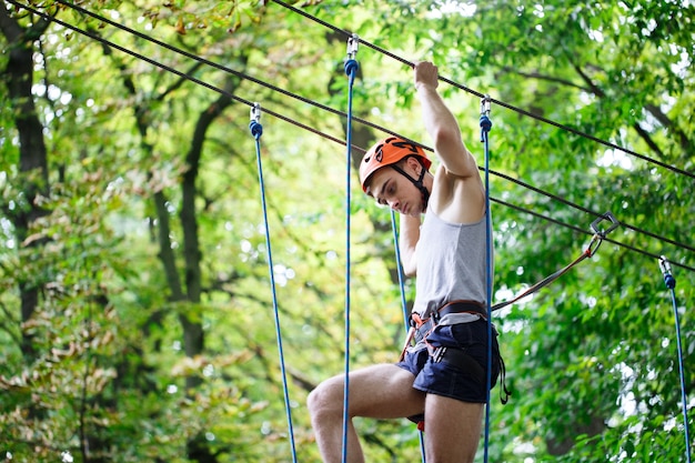 Man steps on the rope hanging in the air