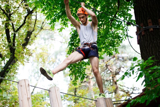 Man steps on the wooden blocks hanging in the air