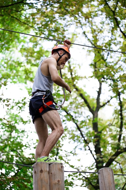 Man steps on the wooden blocks hanging in the air