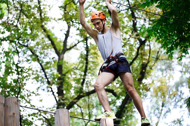 Man steps on the wooden blocks hanging in the air