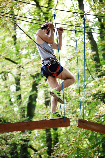 Man steps on the wooden blocks hanging in the air