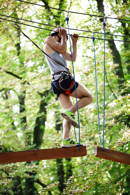 Man steps on the wooden blocks hanging in the air