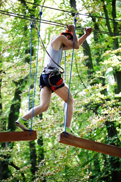 Man steps on the wooden blocks hanging in the air