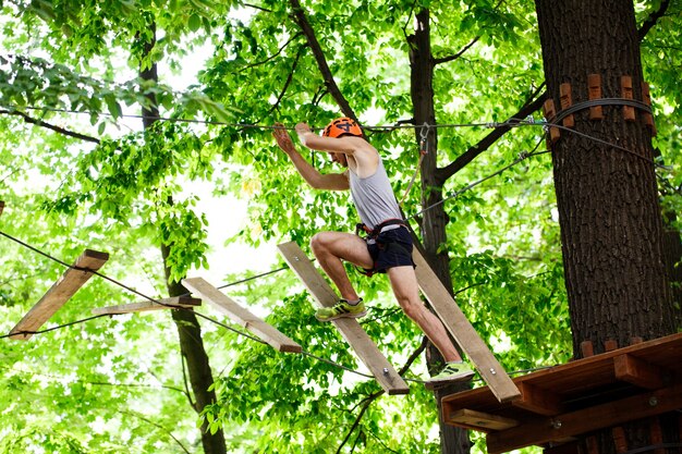 Man steps on the wooden blocks hanging in the air