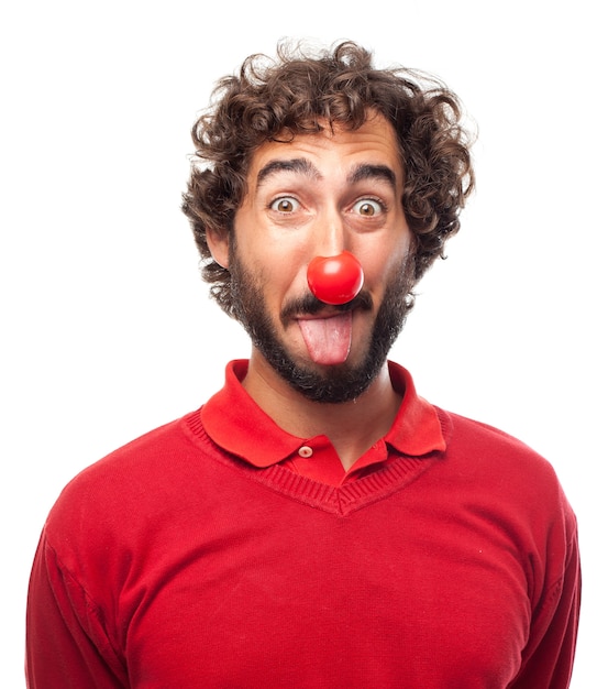 Free photo man sticking out his tongue with a red nose