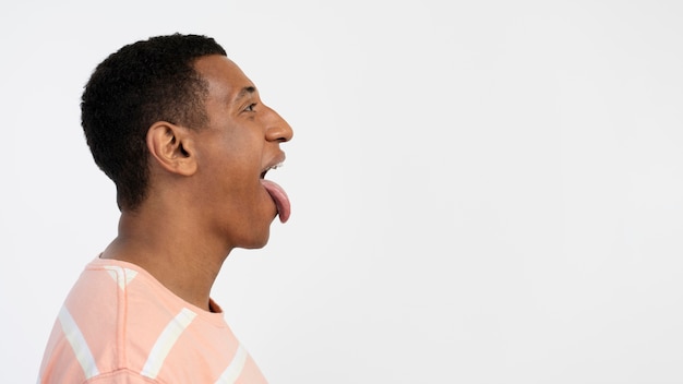 Man sticking out the tongue side view