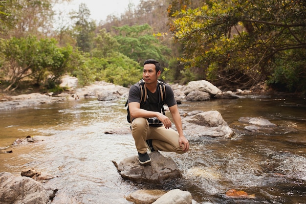 Man on stone in wilderness