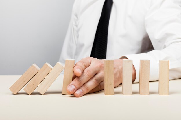 man stopping the wooden pieces of fall concept