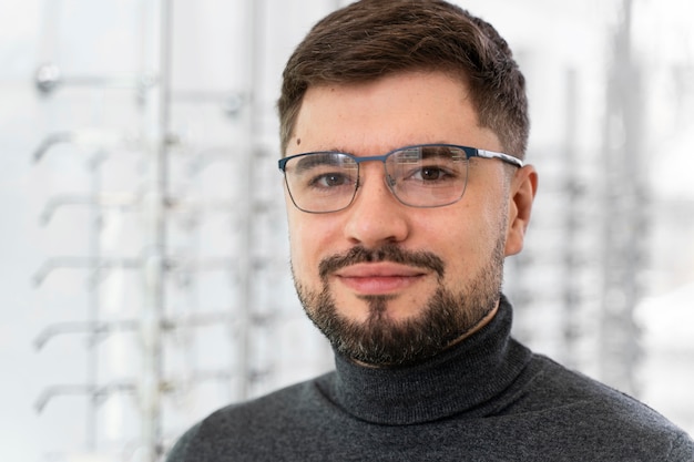 Man at store  trying on glasses