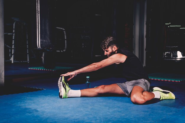 Man stretching in gym