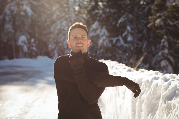 Man stretching his hands in forest