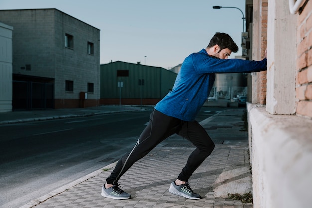 Man stretching on pavement