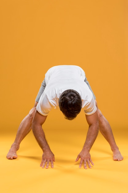 Free photo man stretching in yoga pose