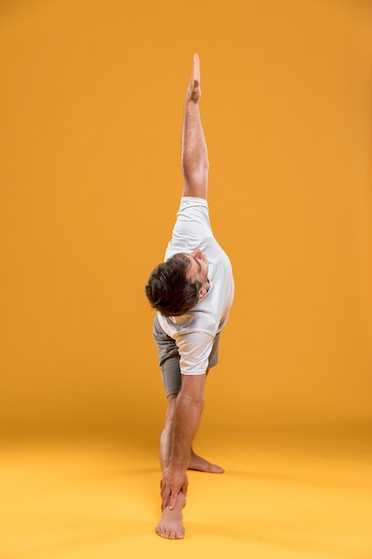 Free photo man stretching in yoga pose