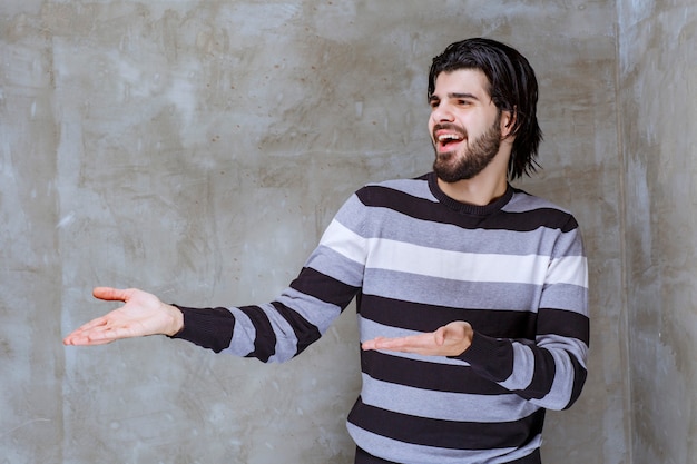 Man in striped shirt looks surprised and confused