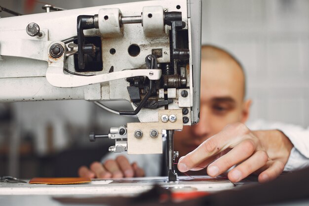 Man in a studio creates leather ware