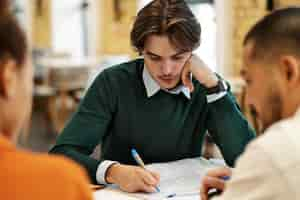 Free photo man studying grammar with his colleagues