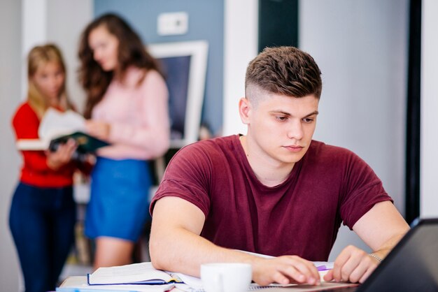 Man studying with laptop at desk