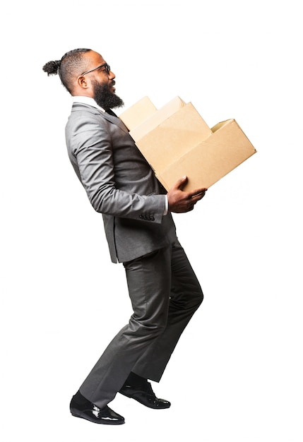 Free photo man in suit carrying a bunch of boxes