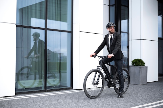 Man in suit cycling to work side view