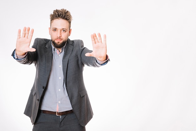 Free photo man in suit gesturing stop