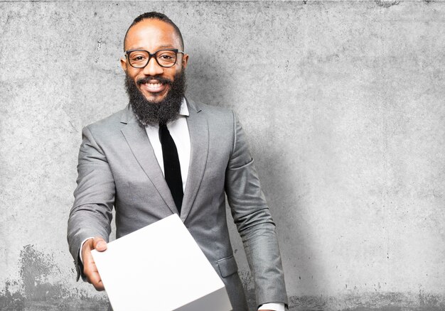 Man in suit handing a box