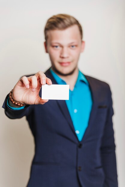 Man in suit holding visiting ca