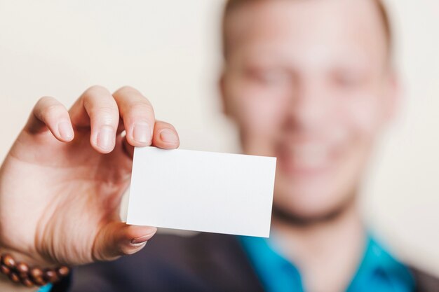 Man in suit holding visiting card