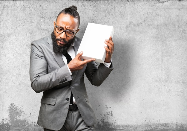 Free photo man in suit listening a box