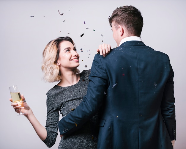 Man in suit looking at woman with champagne glass